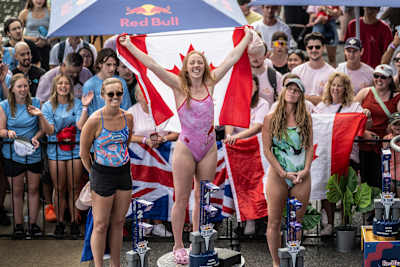 Rhiannan Iffland of Australia, Molly Carlson of Canada and Kaylea Arnett of the USA react on the podium during the Red Bull Cliff Diving World Series in Montreal, Canada on August 25, 2024. 