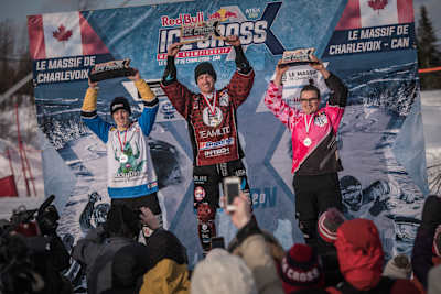 Kyle Croxall celebrates on the podium with Marco Dallago (L) and John Fisher (R) at the Red Bull Ice Cross World Championship stop in Le Massif de Charlevoix, Canada on February 22, 2020.
