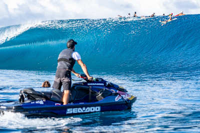 Surfers ride a huge wave in Tahiti during the filming of Big-Wave Surfing.
