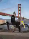 Danny MacAskill on his bike looking out towards Golden Gate Bridge, San Francisco, USA.