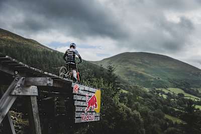 Gee Atherton looks out over the road gap on the Red Bull Hardline 2022 course.