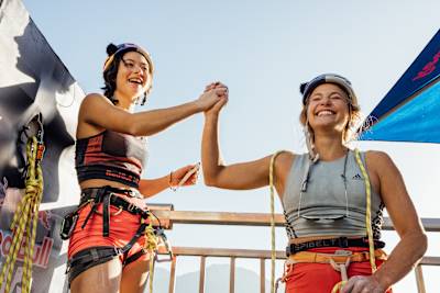 Sasha DiGiulian and Angie Scarth Johnson celebrate the finish of their climb in Red Bull Dual Ascent in Locarno, Switzerland on October 27th, 2022.