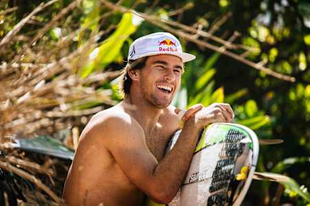 Jack Robinson sitting on the beach at Pipeline, on the North Shore of Oahu, Hawaii. 