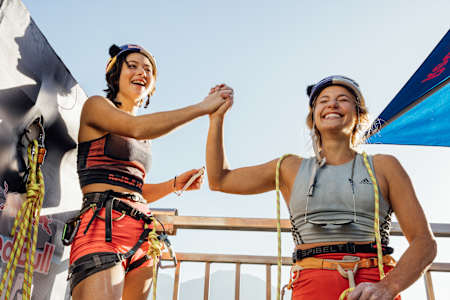 Sasha DiGiulian and Angie Scarth Johnson celebrate the finish of their climb in Red Bull Dual Ascent in Locarno, Switzerland on October 27th, 2022.