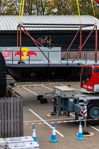BMX star Kriss Kyle riding in the Don't Look Down skatepark bowl that is being suspended by cranes in an engineering feat.