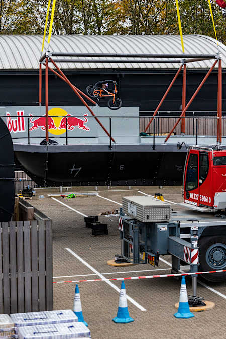 BMX star Kriss Kyle riding in the Don't Look Down skatepark bowl that is being suspended by cranes in an engineering feat.