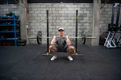 Brook Macdonald performs a squat hold during a workout in a gym in Wellington, New Zealand, in April 2019.