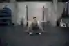 Brook Macdonald performs a squat hold during a workout in a gym in Wellington, New Zealand, in April 2019.