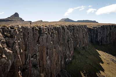 Runners on top of sheer rock cliff - part of the Ultra Trail on the Drakensberg.