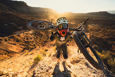 Brett Rheeder carries his bike up the course at Red Bull Rampage 2022.
