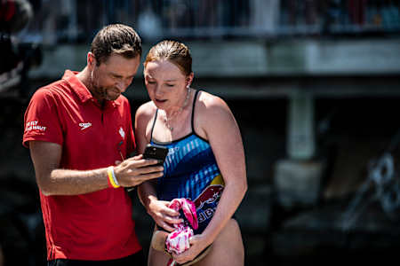 Coach Stephane Lapointe (L) talks with Molly Carlson during the Red Bull Cliff Diving World Series in Boston, USA on June 2, 2023.