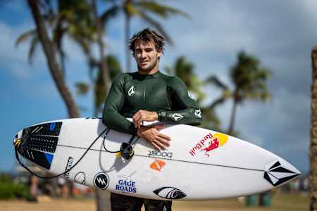 Jack Robinson gets ready to surf in Hawaii.