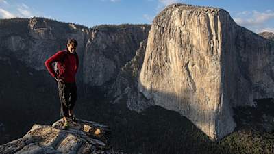 Alex Honnold stand in front of El Capitan in Yosemite.