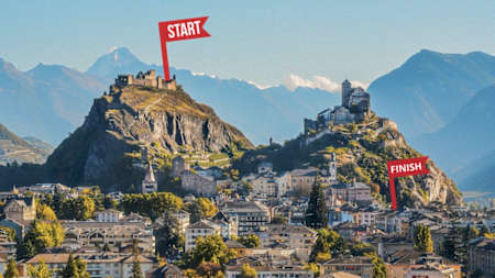 The city of Sion showing two mountains with castles at the top: the left has a start flag, the right has a finish flag, mapping out the course for Castle Rock.