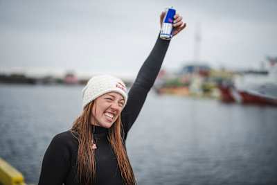 Molly Carlson celebrates after becoming the first woman in the world to dive from an iceberg in October, 2026.