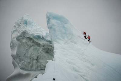 Will Gadd and Molly Carlson climb a 15m iceberg in the Atlantic Ocean ahead of Carlson's world-first dive in October, 2026.