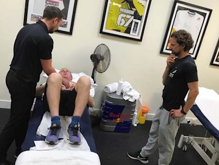 Me getting some physio from Jeff Ross while my coach, Blakey, looks on.