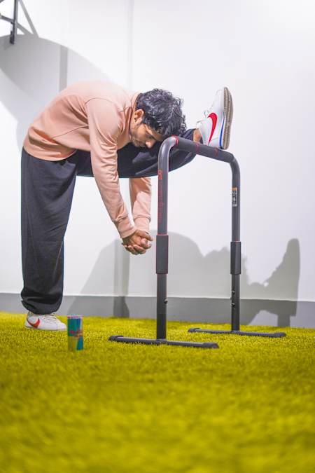 Fitness trainer Karan Bagri performs a Shaolin stretch in his home gym.
