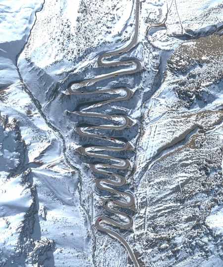 Winding road of Los Caracoles Pass seen in snow.