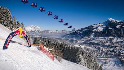 A wingsuit pilot from the Red Bull Skydive team flies down the Streif downhill track in Kitbuehel, Austria.