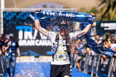 Tom Evans crossing the finish line at Transgrancanaria in 2022.