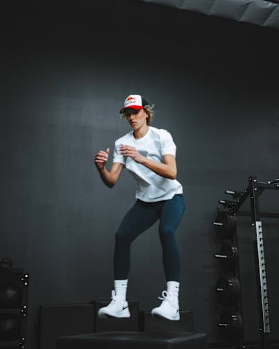 American volleyball star Madisen Skinner performs plyometrics in the gym.