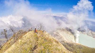 An adventurer sat on mountain in Indonesia.