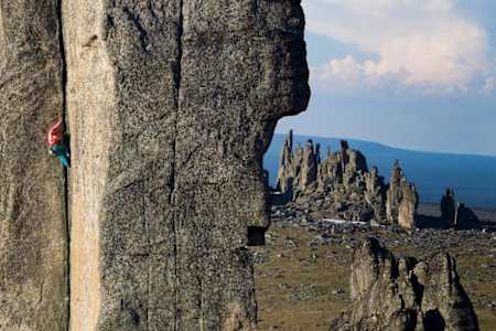 A climber goes up a rock formation in the Ulakhan-Sis region of Siberia.