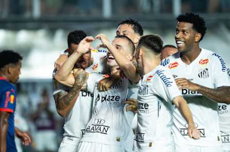 Joao Schmidt of Santos Futebol Clube celebrates with teammates after scoring his team's second goal during the Campeonato Paulista Quarter-Final match.