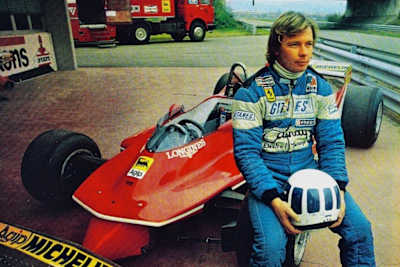 Didier Pironi poses with his Ferrari F1 car in the pit lane at the Fiorano test track.
