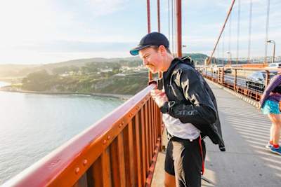 Rickey Gates looks over the edge of the Golden Gate Bridge during his 46 day marathon run over every single street in the city of San Francisco.