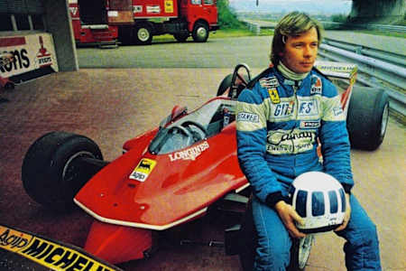 Didier Pironi poses with his Ferrari F1 car in the pit lane at the Fiorano test track.