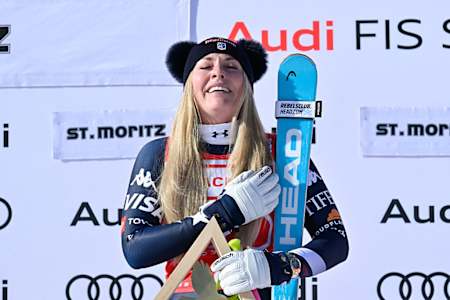 Lindsey Vonn listens to the US national anthem after winning the downhill race at the FIS Alpine Skiing World Cup in St Moritx, Switzerland on December 12, 2025.
