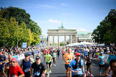 Runners running through the Brandenburg Gate during the 2025 BMW Berlin Marathon on September 21, 2025 in Berlin, Germany.