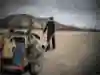 Global walker Angela Maxwell drags her buggy of gear on the road in Mongolia.