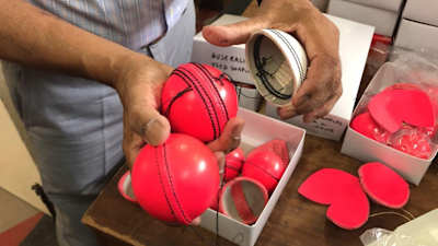 Dukes cricket balls in pink and white colours.