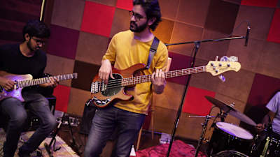 Musicians perform in the recording booth of Compass Box Studio.