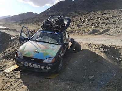 A photo of Krakota's Ford Fiesta car during the Mongol Rally, with all his kit stored on the roof.
