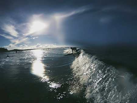A man surfs a wave off Siargao Island in the Philippines.