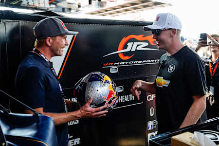 Connor Zilisch recieves a Red Bull helmet from Scott Speed at Watkins Glen International on September 14, 2024.