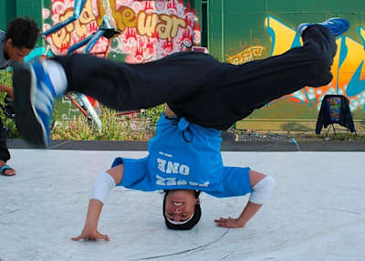 B-Girl Aruna standing on her head creating momentum to spin