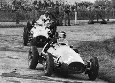 A photo of F1 drivers taking a corner during the 1953 German Grand Prix at the Nürburgring.