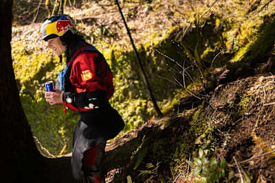 Nouria Newman looking down at a waterfall in the forest during a photo shoot in France on March 22, 2022.