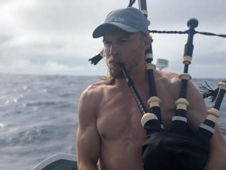 Jamie MacLean playing the bagpipes during an Atlantic row