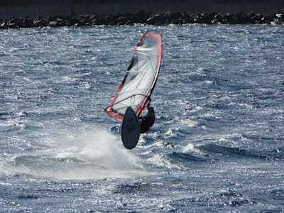 A windsurfer takes to the water off Faial Island in the Azores.