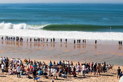 Crowds watch an empty wave at Peniche, Portugal.