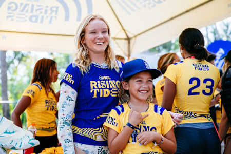 Caity Simmers hanging with local kids in El Salvador, for WSL Rising Tides.