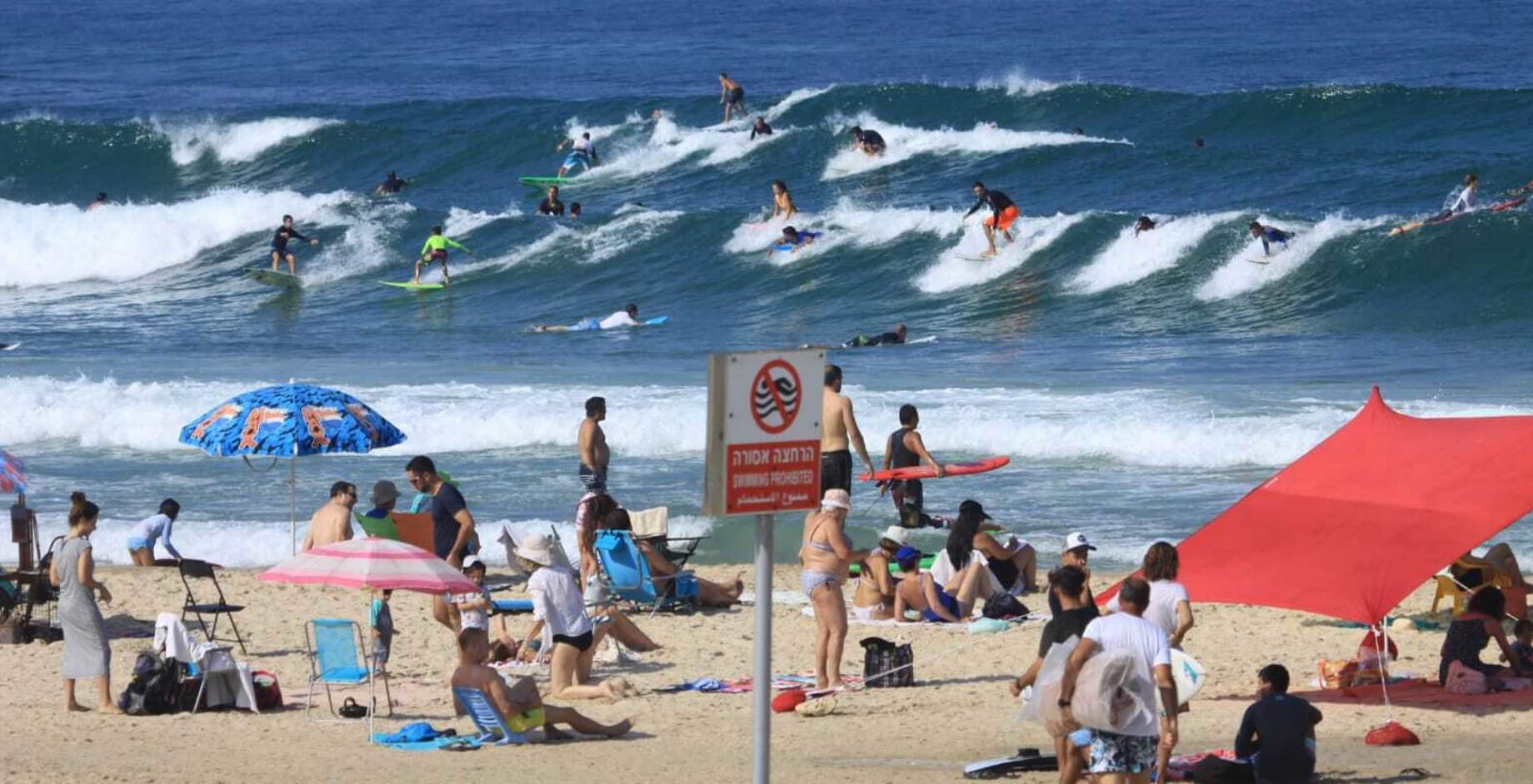 A busy surfing beach in Israel.