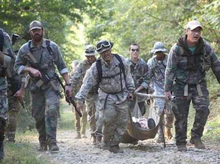 Participants carry a body during the Commando Challenge race.