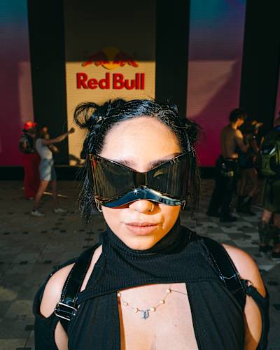 Portrait of a balck-clad festivalgoer in massive sunglasses at Red Bull Mirage during Coachella Music and Arts Festival on April 11, 2025. 